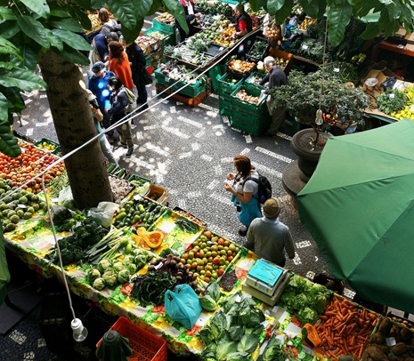 Birds eye view of market stalls with colourful fruit and veg