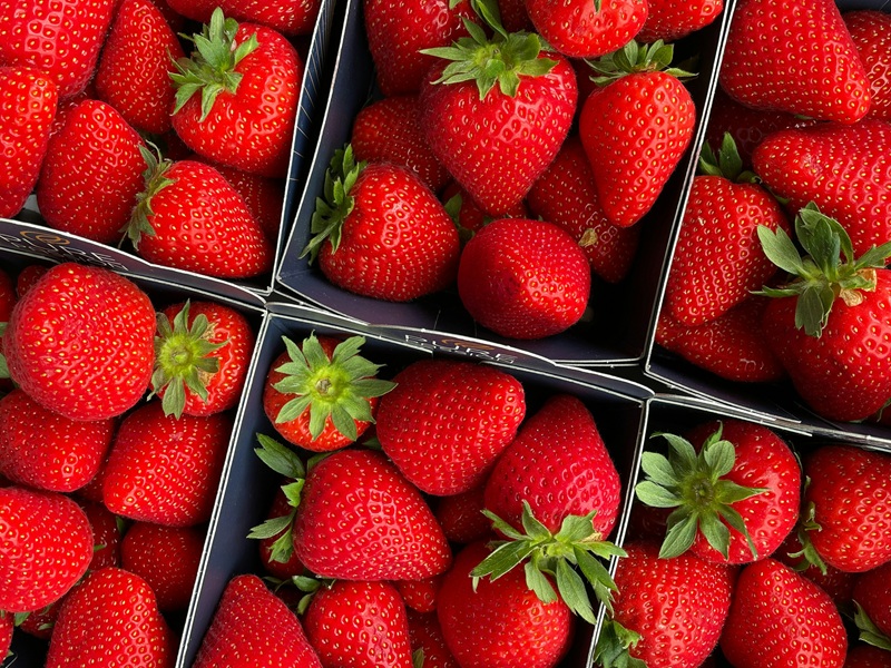 close up of strawberries displayed in a market