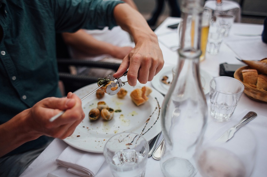 A diner tucking into a plate of snails in France