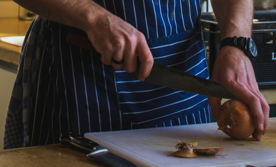 Close up of a chef chopping onions