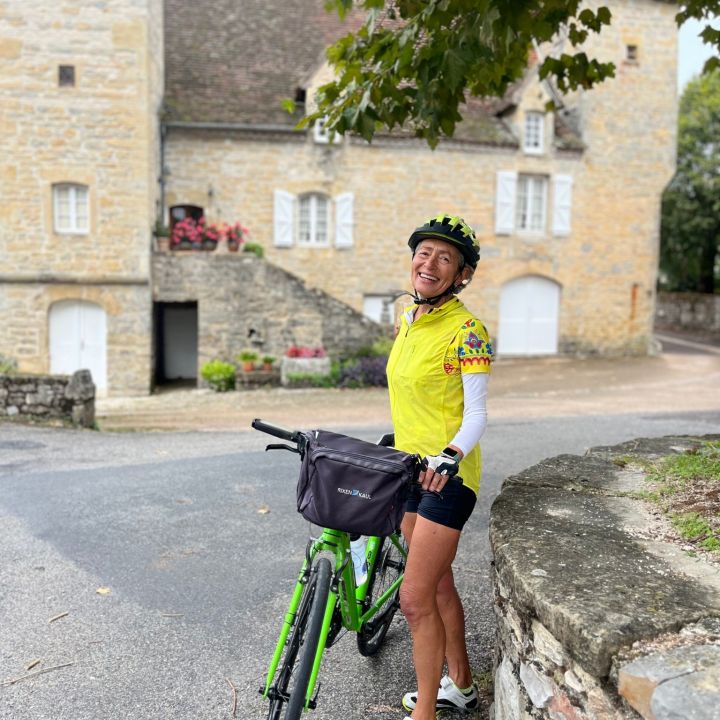 Female cyclist on a guided tour in the Dordogne, France